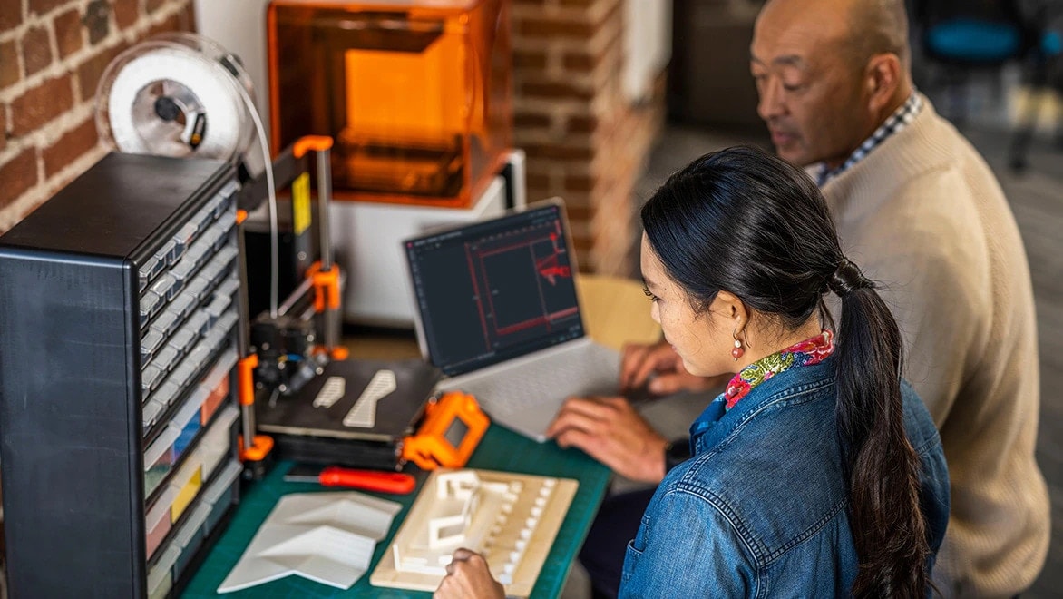 Two people using AutoCAD on a mobile environment