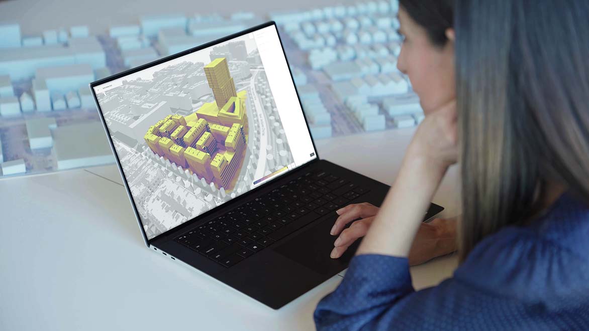Person using Autodesk Forma to analyze a 3D model of a building complex