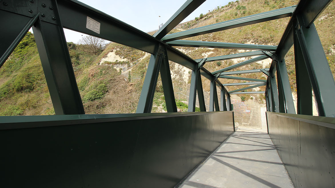 Image shows a close-up of the fibre-glass beams and connectors after the footbridge was installed 