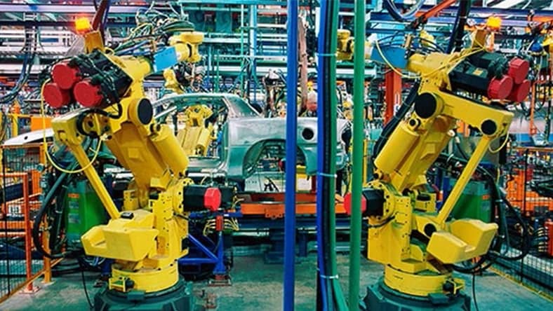 Robotic arms on an automated assembly line in an automotive plant.