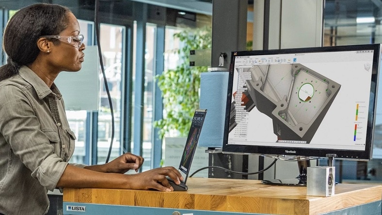 Woman examines a product design on a computer screen.